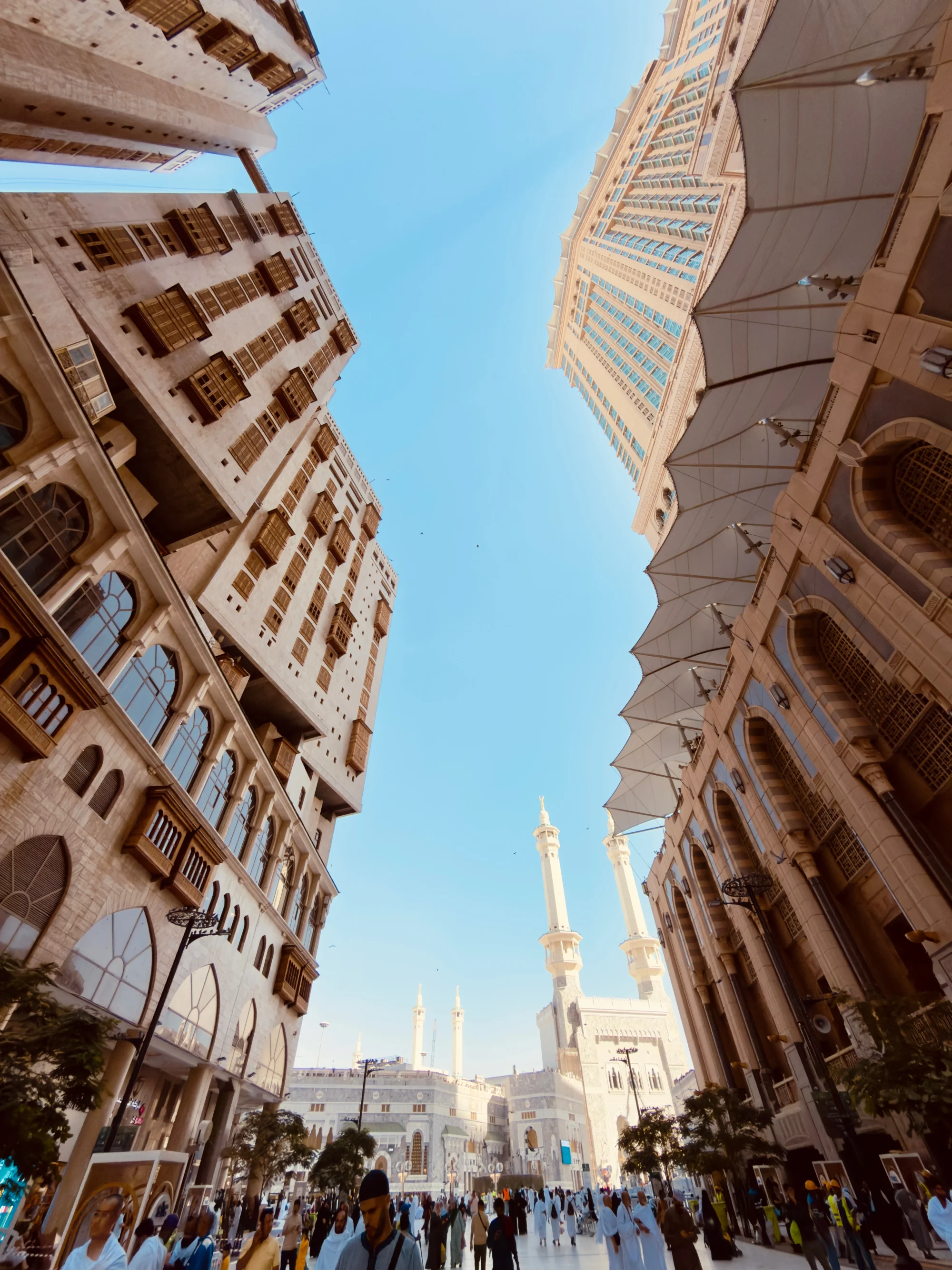 Looking up a narrow street towards distant minarets