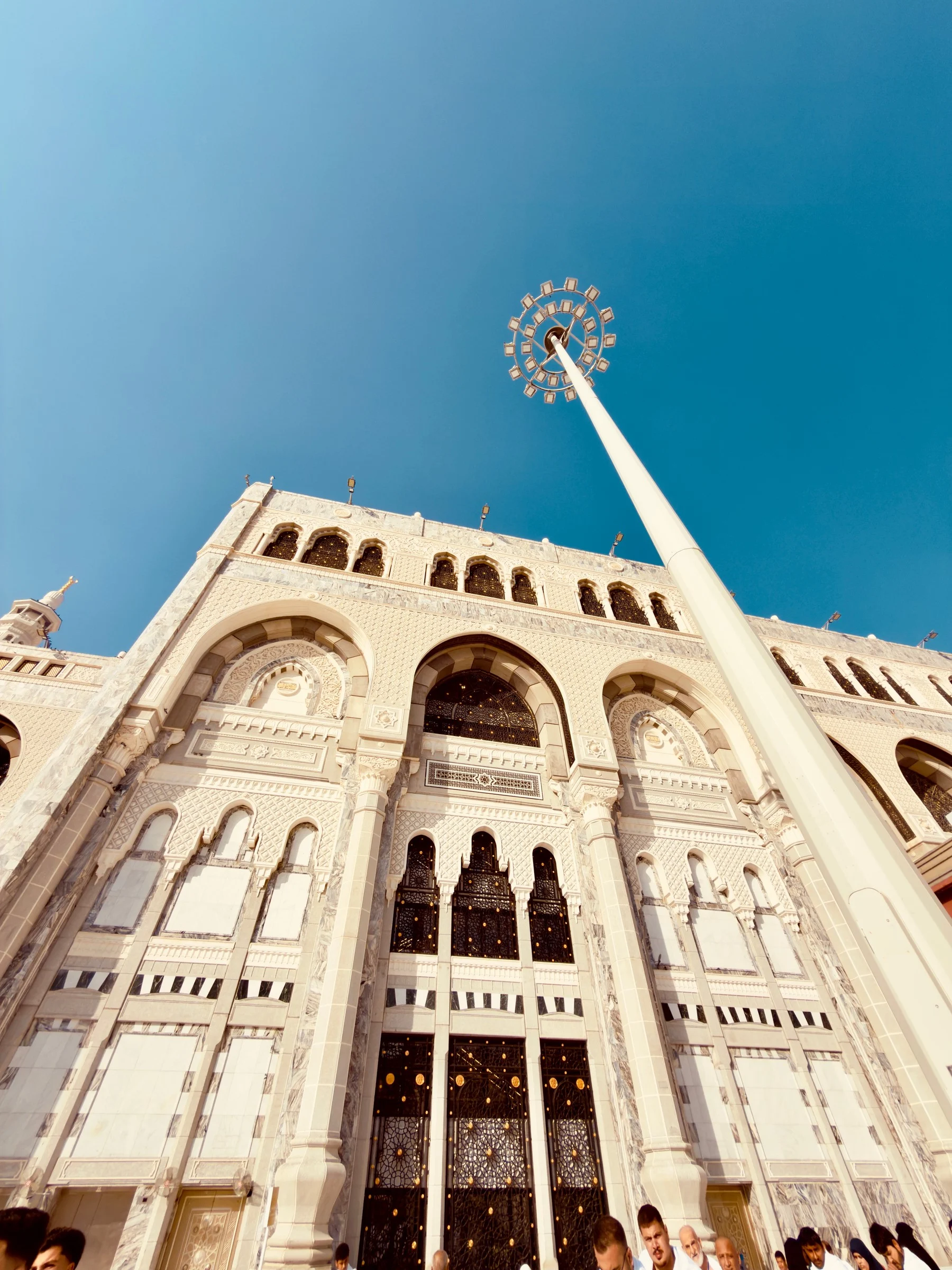 A marble facade and tall doors seen from below