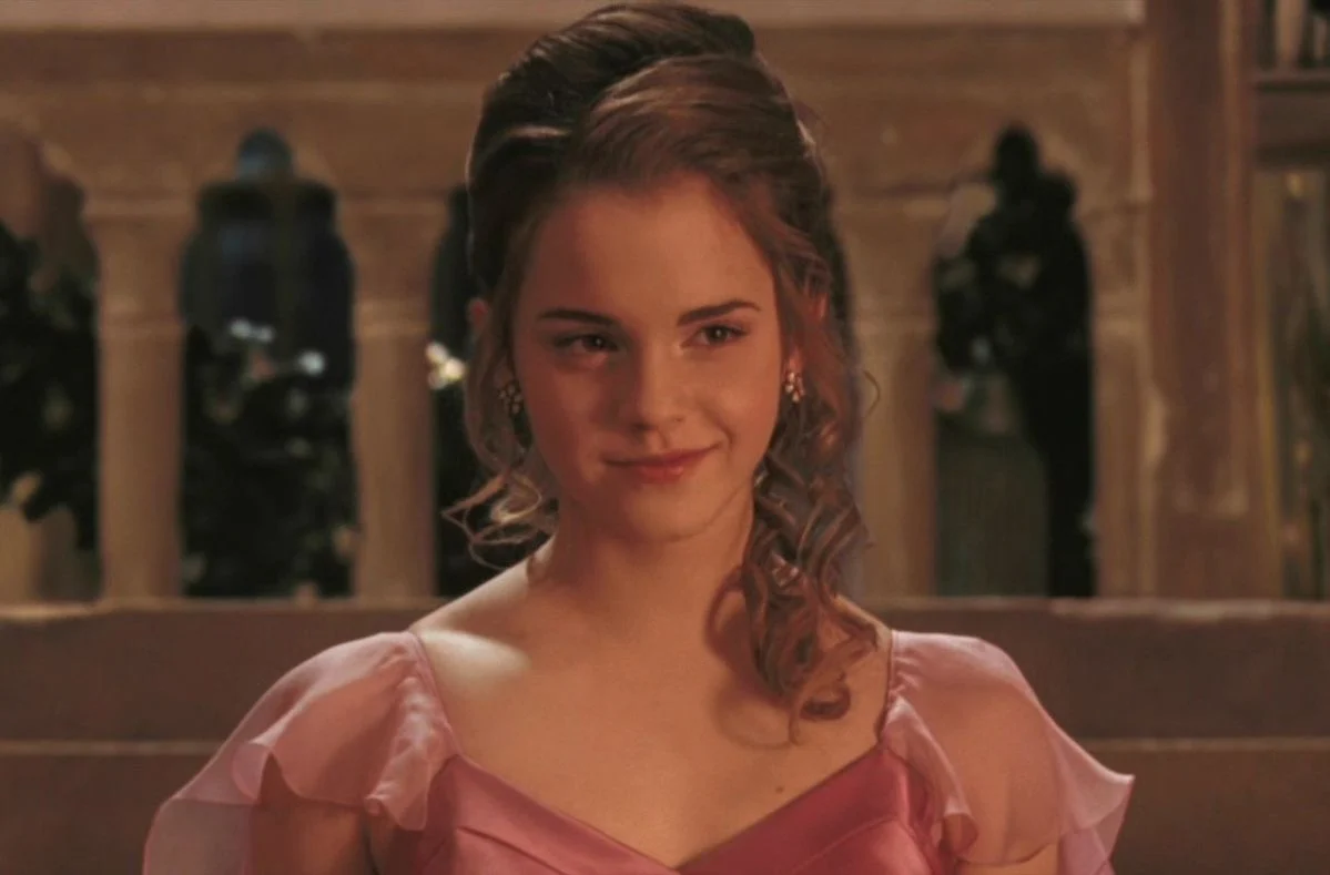 Hermione at the Yule Ball in a pink gown, hair pinned up