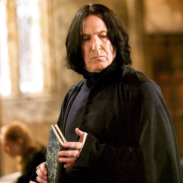 Severus Snape holding a book