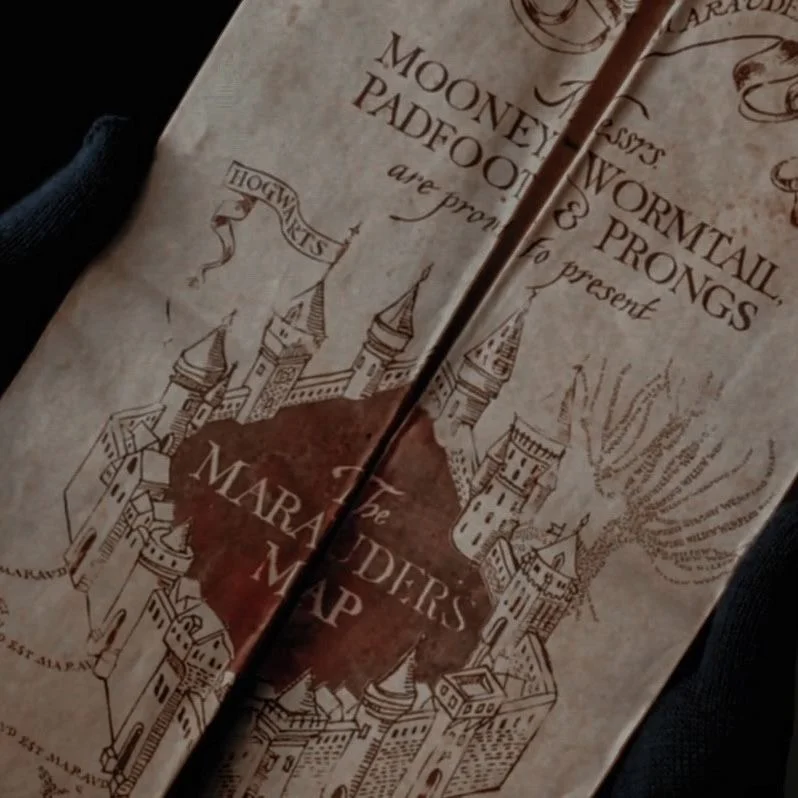 The Marauder's Map unfolded in gloved hands