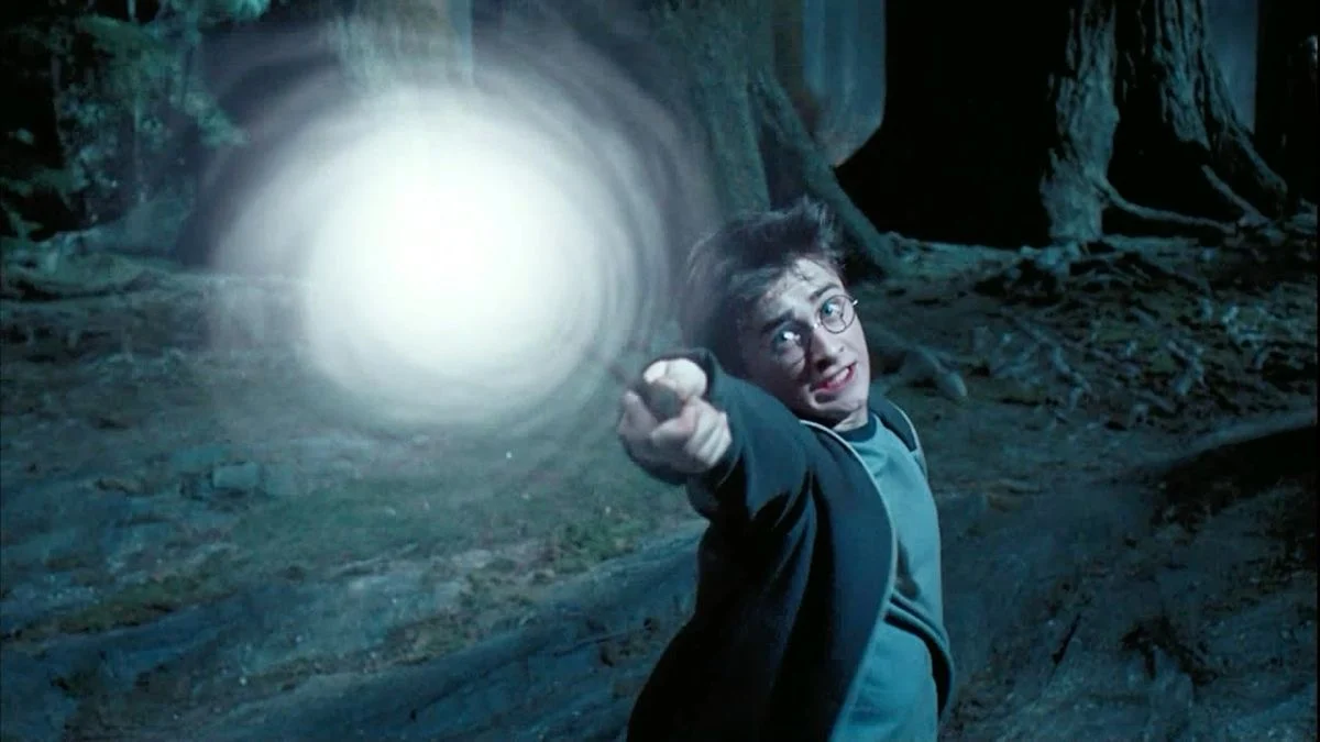 Harry casting a patronus in the forest