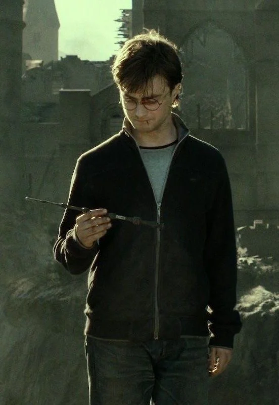 Harry examining the Elder Wand in the ruins