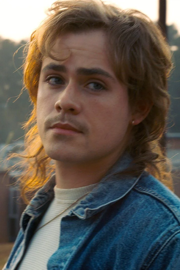 Billy Hargrove at sunset in a denim jacket