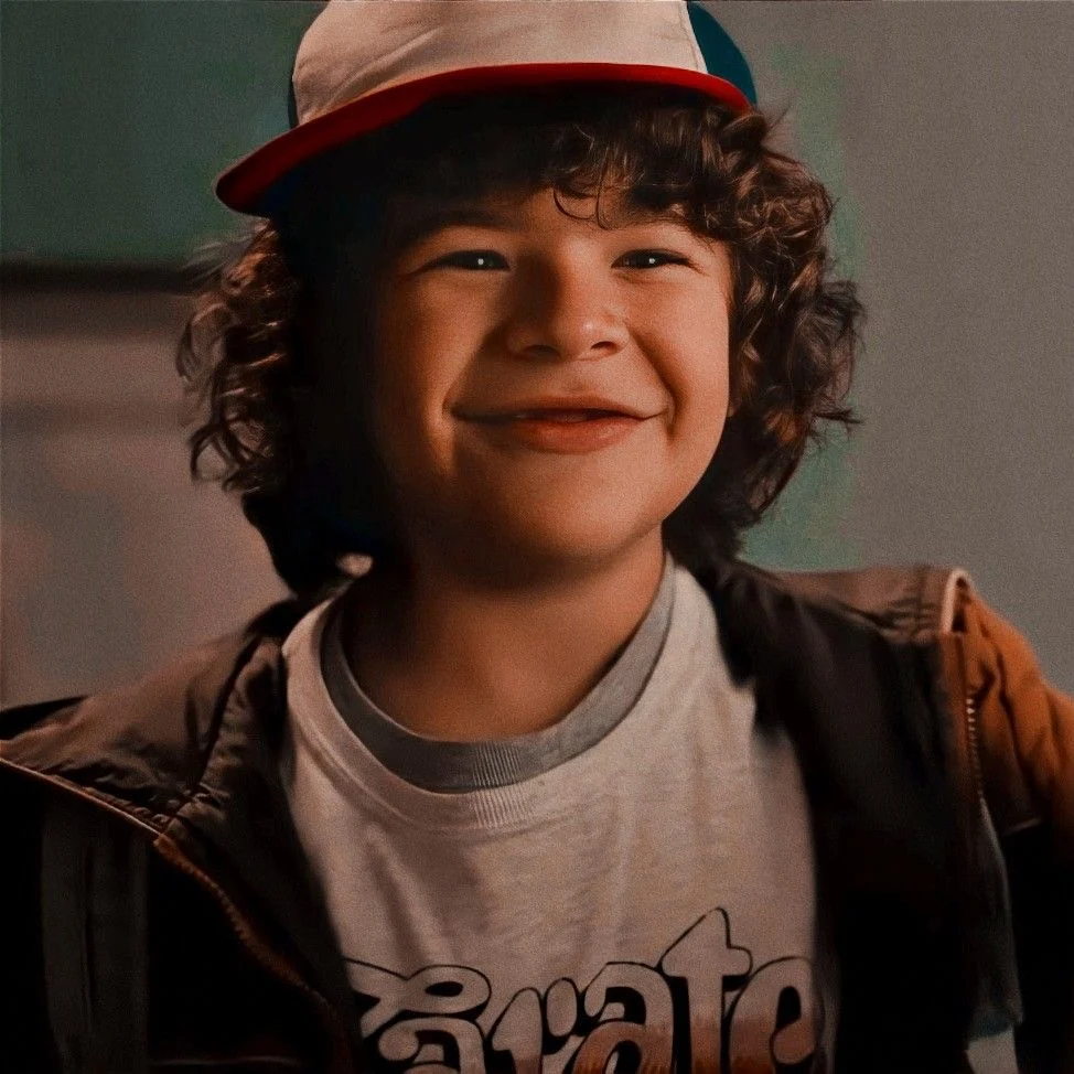 Dustin grinning under a baseball cap