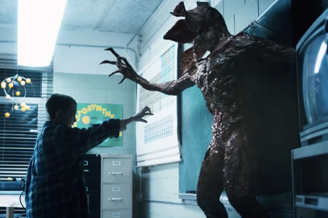 Eleven facing a Demogorgon across a school classroom