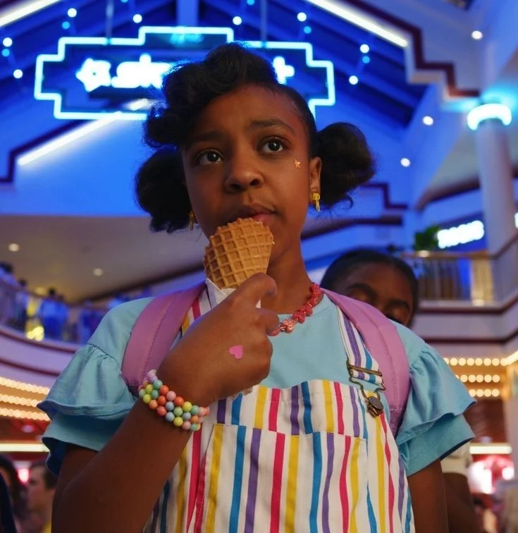 Erica Sinclair eating an ice cream cone in the Starcourt Mall