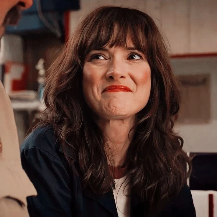 Joyce Byers half smiling