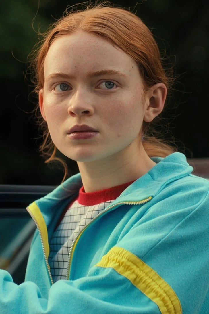 Max in a teal tracksuit jacket
